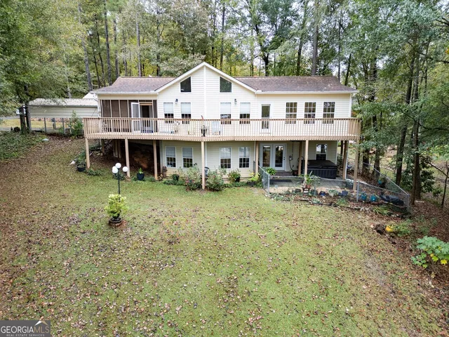 an aerial view of a house with a yard and outdoor seating