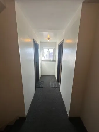 a view of an empty room with a window