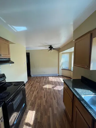 a kitchen with granite countertop a refrigerator and a sink