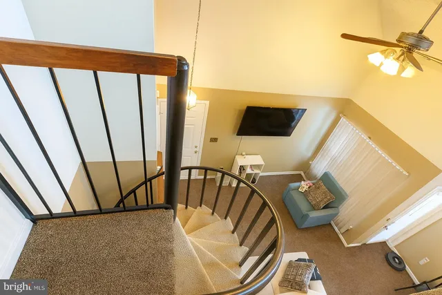 a view of a living room with furniture and a floor to ceiling window