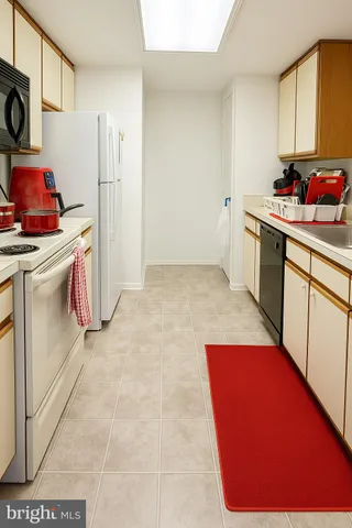 a kitchen with a sink stove and refrigerator