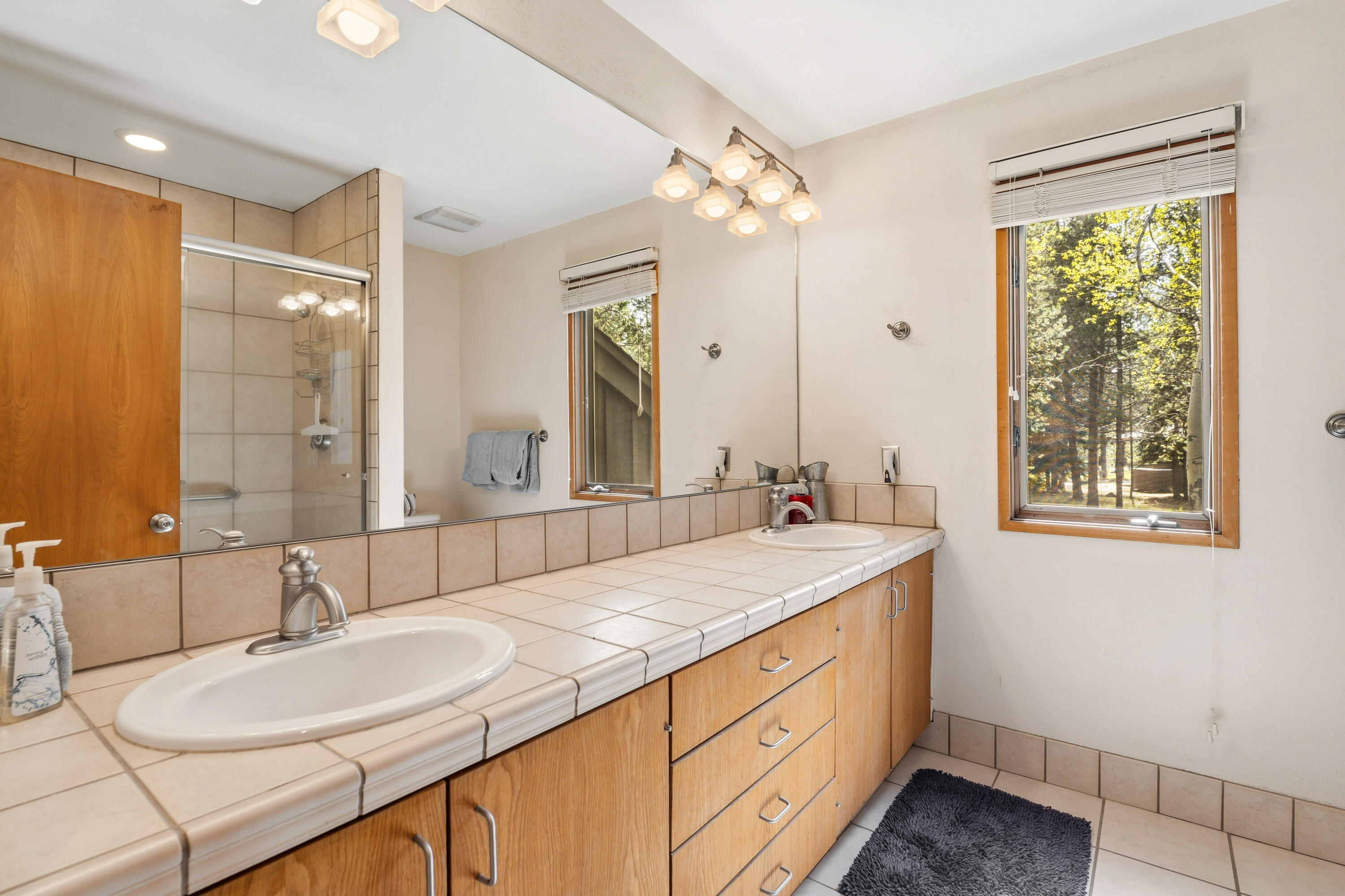 17866 Grouse Lane, Unit 3 Sunriver, OR 97707 - Photo 31 of 61 a bathroom with a sink double vanity and a mirror