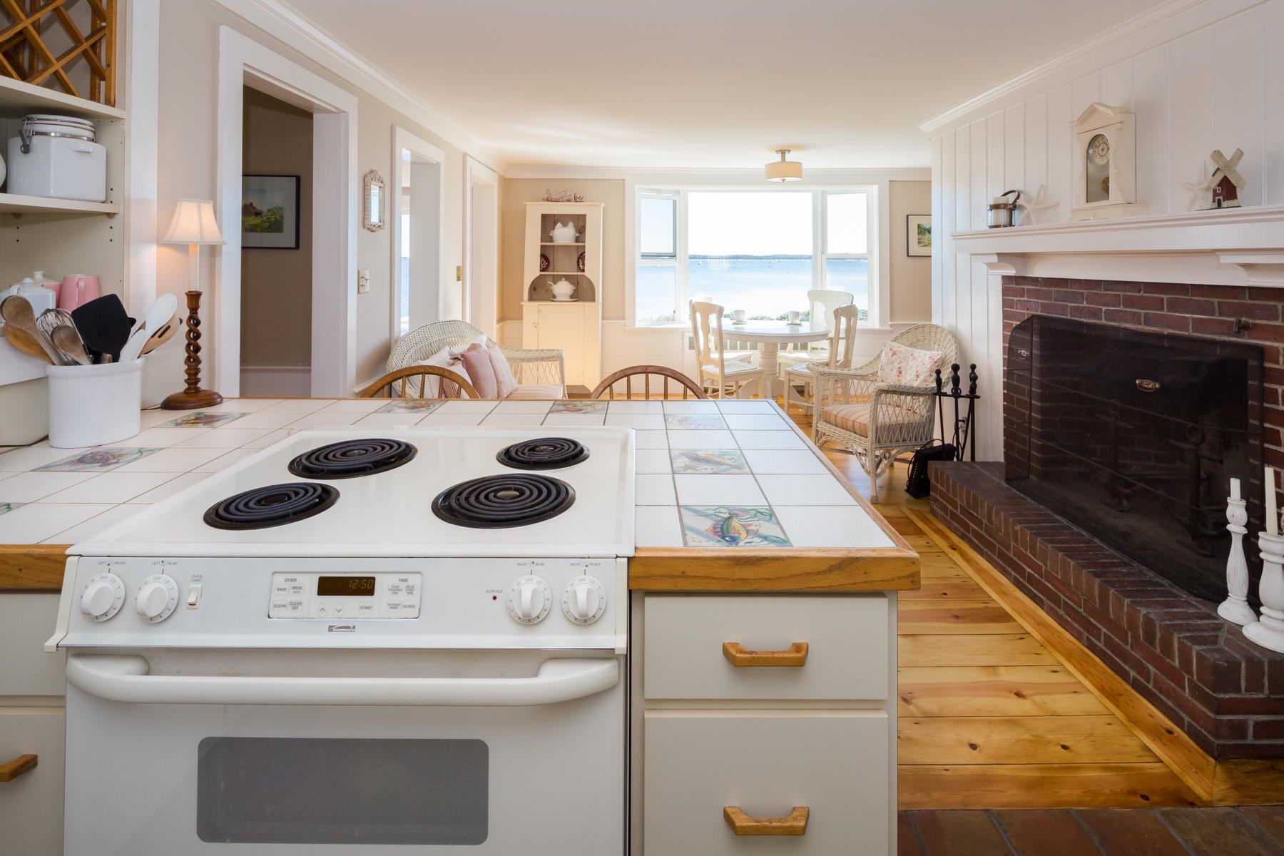 97 Harbor Bluff Road Hyannis, MA 02601 - Photo 20 of 33 a kitchen with a stove a sink and a refrigerator with white cabinets
