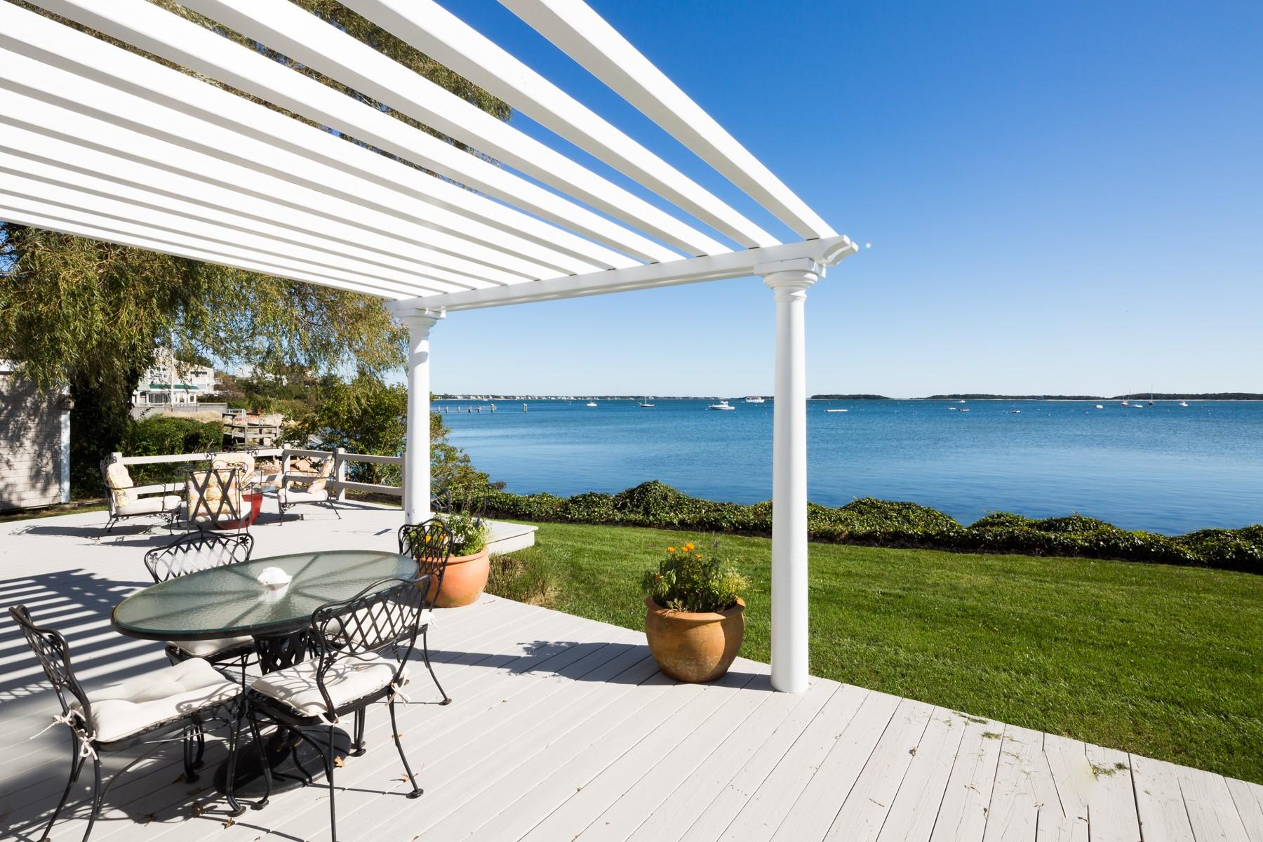 97 Harbor Bluff Road Hyannis, MA 02601 - Photo 8 of 33 a view of a patio with lawn chairs floor to ceiling window yard and ocean view