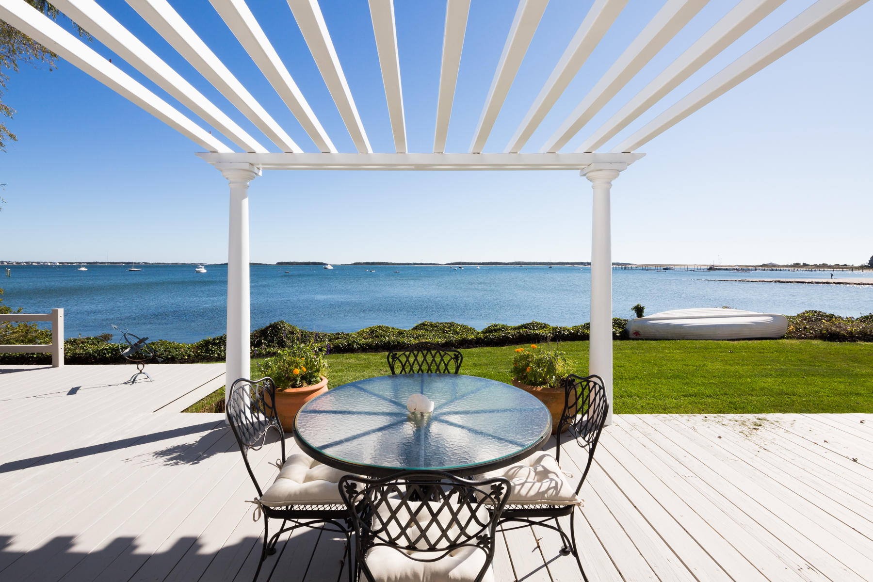 97 Harbor Bluff Road Hyannis, MA 02601 - Photo 9 of 33 a balcony with table and chairs
