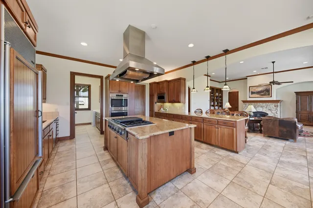 a kitchen with stainless steel appliances granite countertop a sink and a refrigerator
