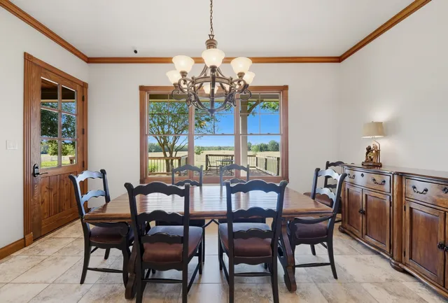 a dining room with furniture a chandelier and a rug