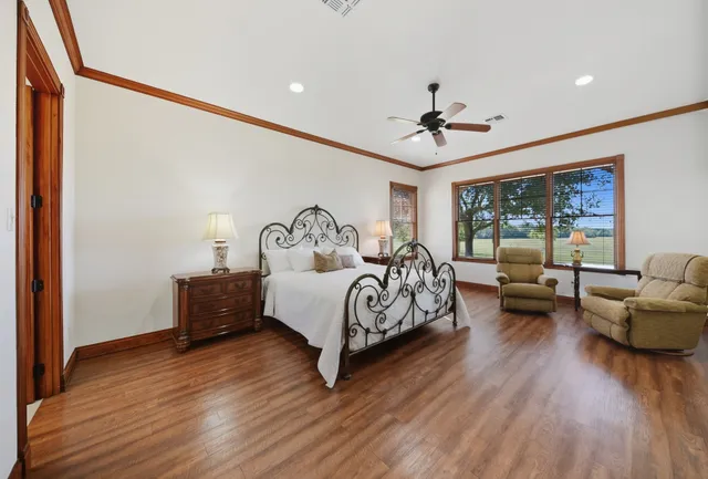 a bedroom with furniture and wooden floor