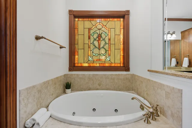 a bathroom with a tub and a shower