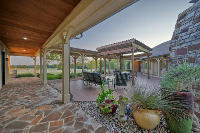 an outdoor view of a house with table and chairs