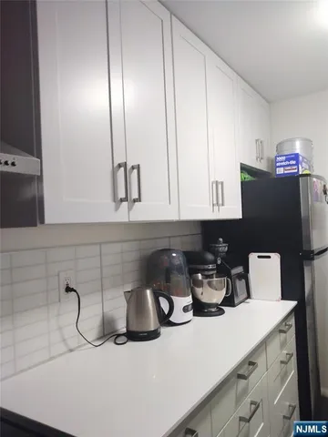 a bathroom with a toilet sink vanity and mirror