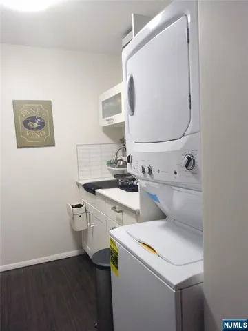 a bed sitting in a bedroom next to a cabinet