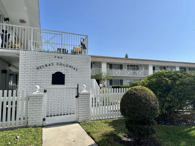 a view of a house with wooden fence