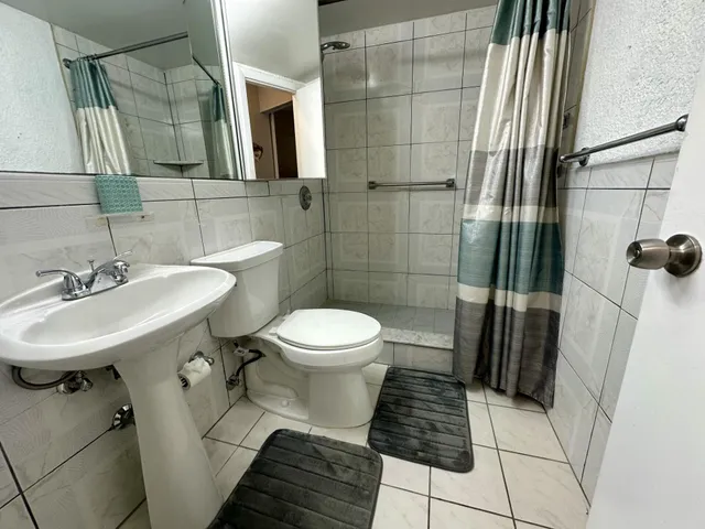 a bathroom with a sink toilet and shower