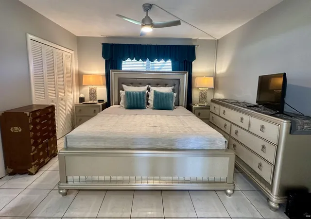 a bedroom with a bed and a television