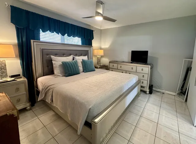 a bedroom with a bed and a television