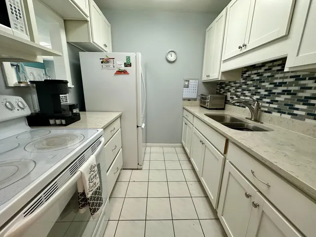 a kitchen with a sink a stove and refrigerator