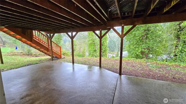 a view of empty room with wooden floor and fence