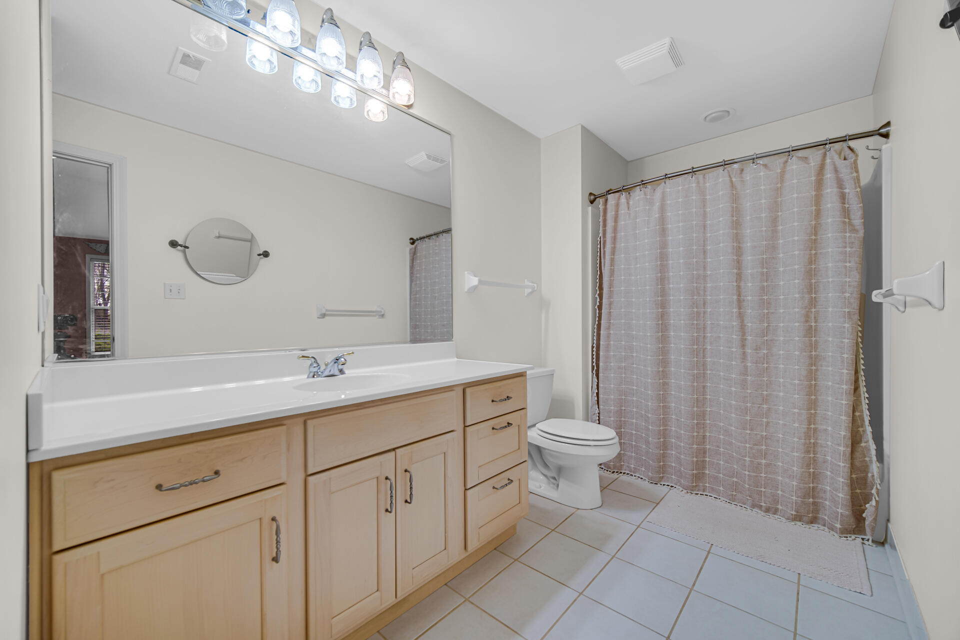 2649 Georgetowne Drive, Unit B2 Highland, IN 46322 - Photo 14 of 20 a bathroom with a double vanity sink a toilet and a mirror