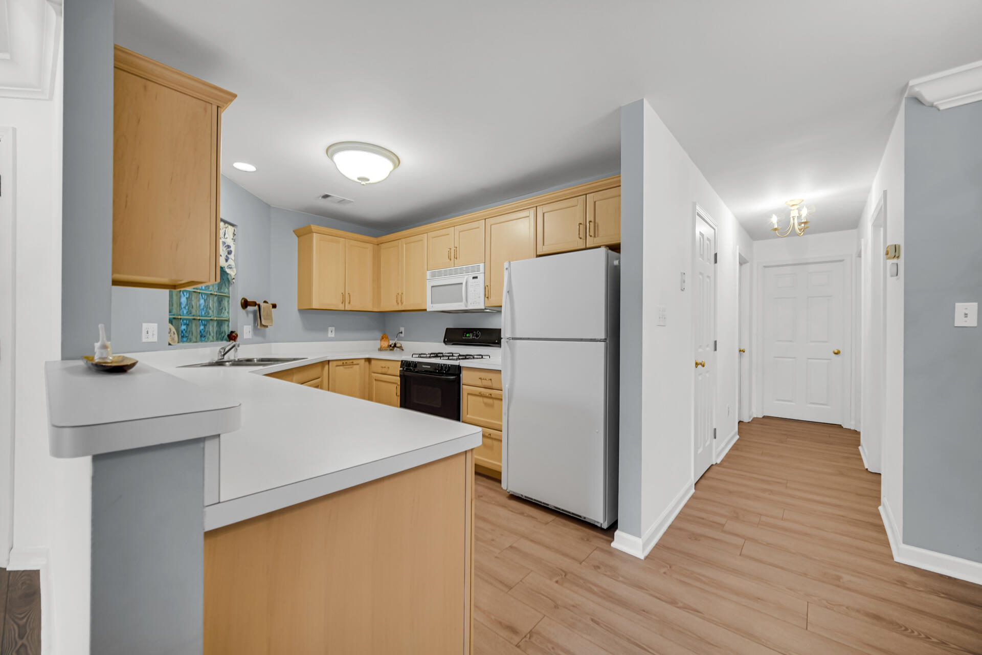 2649 Georgetowne Drive, Unit B2 Highland, IN 46322 - Photo 8 of 20 a kitchen with a refrigerator a sink and cabinets