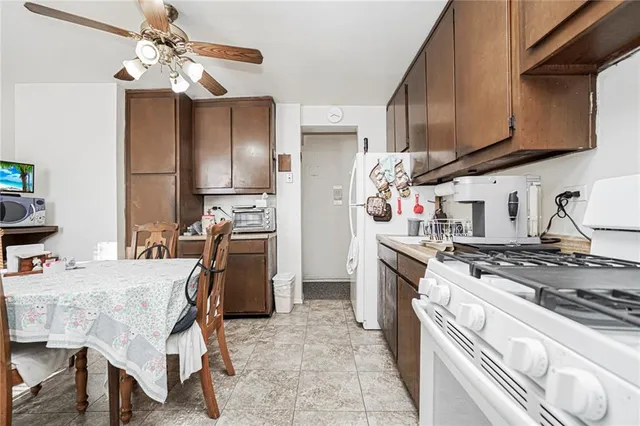 a kitchen with stainless steel appliances granite countertop a stove refrigerator and cabinets