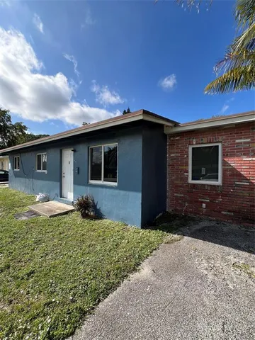 a backyard of a house with yard fire pit barbeque oven and outdoor seating