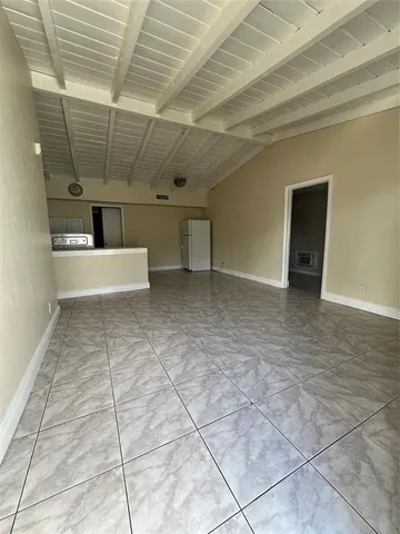 a view of a livingroom with a refrigerator