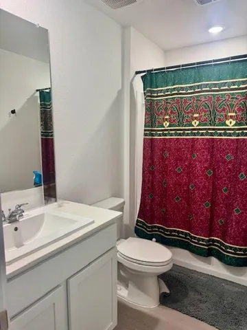 a bedroom with a bed a dresser and a window