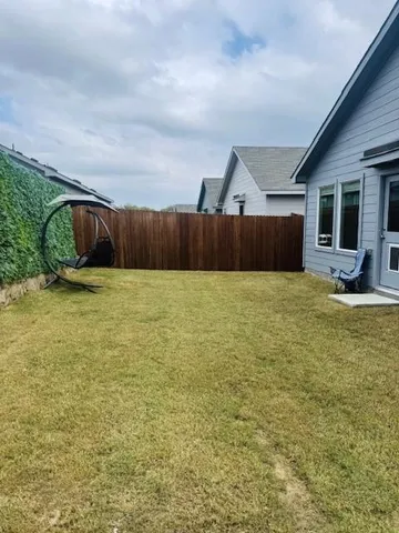 a swimming pool with outdoor seating and yard