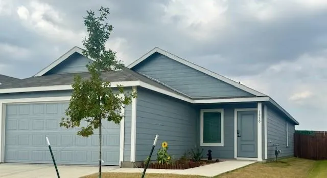 a backyard of a house with table and chairs potted plants