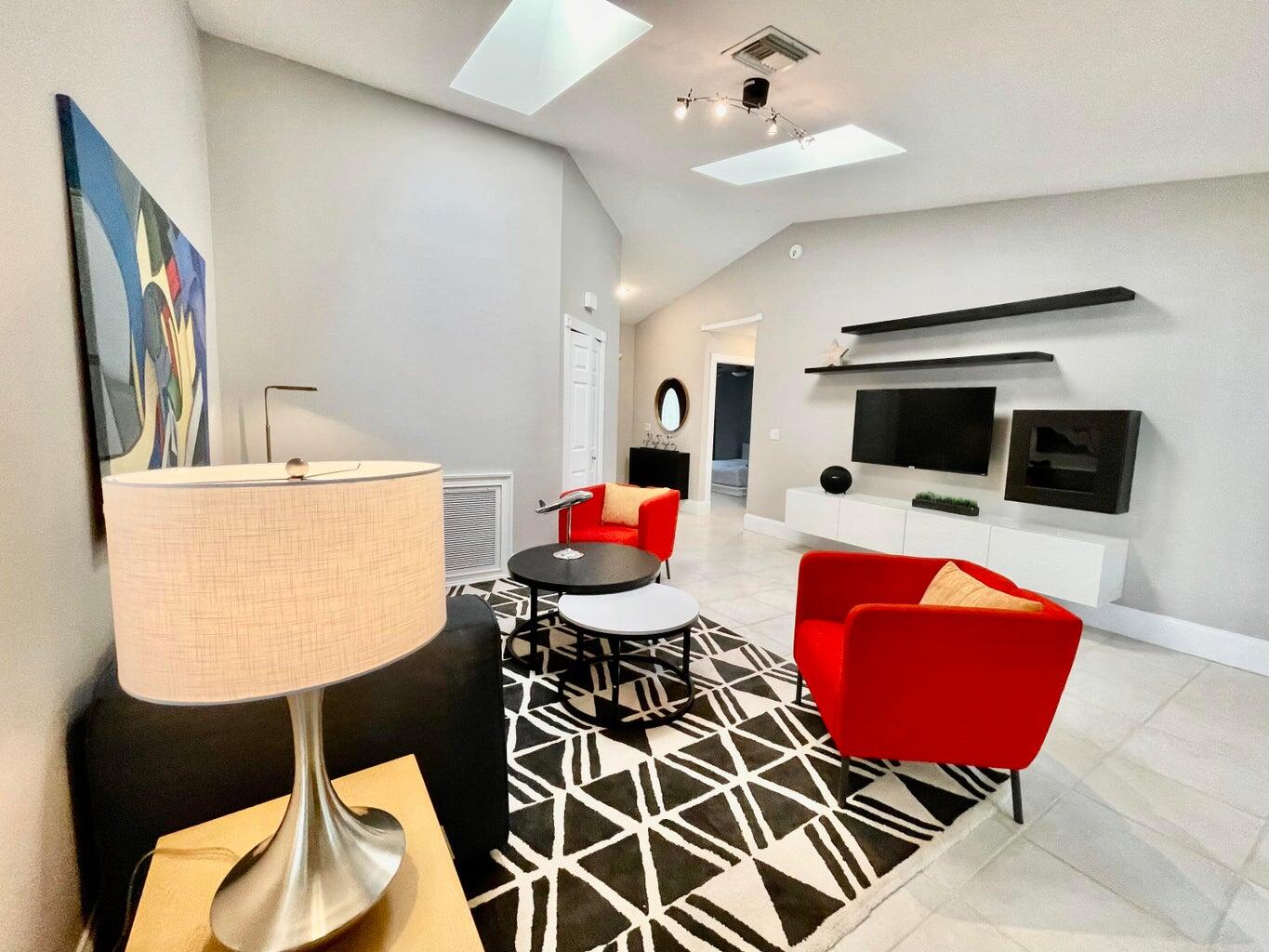 1259 Denlow Lane Royal Palm Beach, FL 33411 - Photo 14 of 40 a living room with furniture a flat screen tv and a table