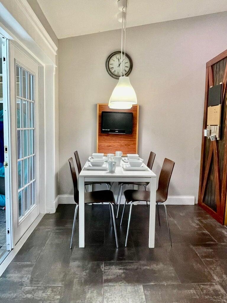 1259 Denlow Lane Royal Palm Beach, FL 33411 - Photo 18 of 40 a view of a dining room with furniture wooden floor and a rug