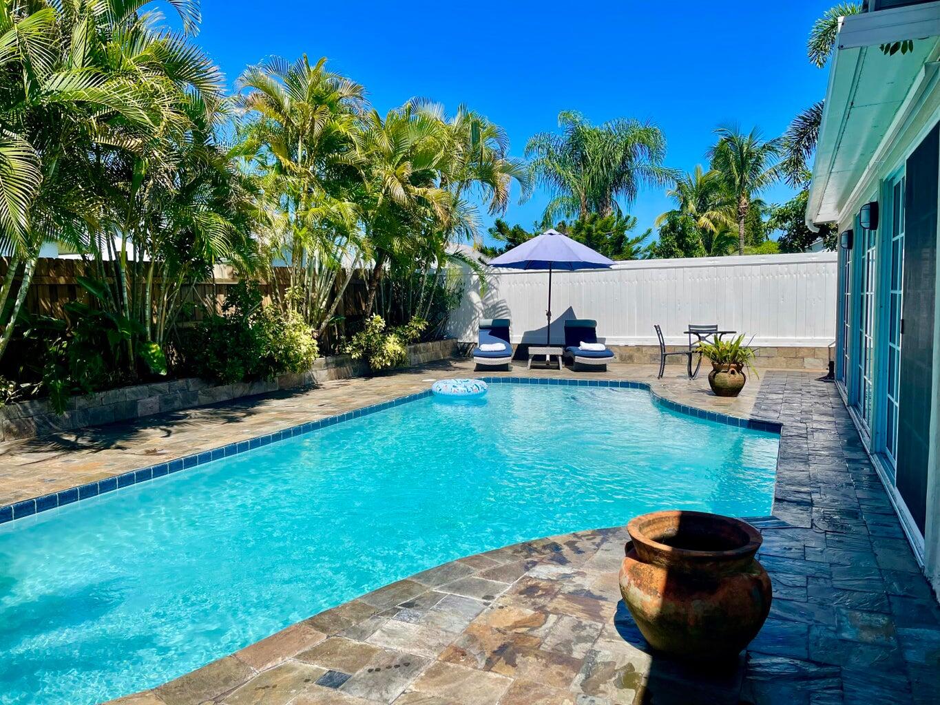 1259 Denlow Lane Royal Palm Beach, FL 33411 - Photo 21 of 40 a backyard of a house with seating space and trees