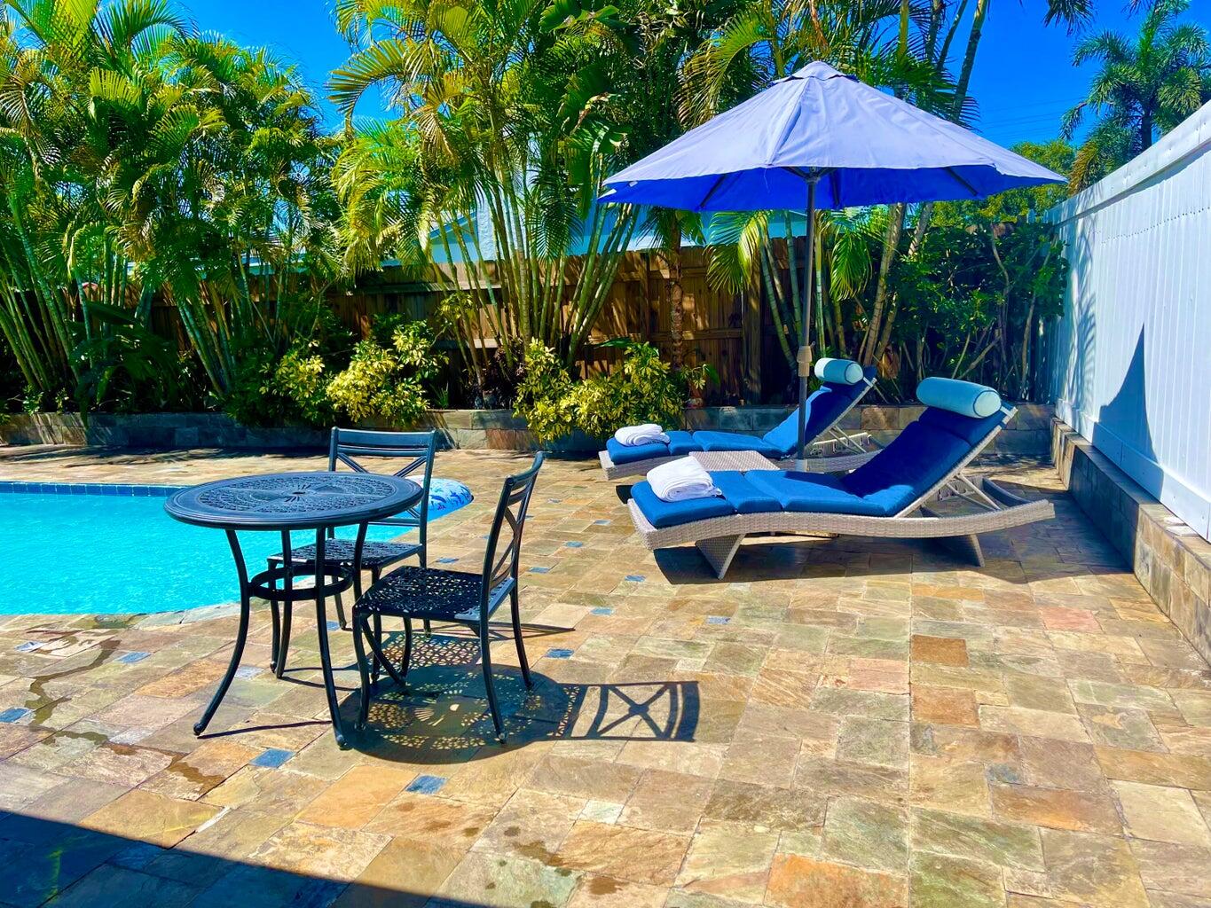 1259 Denlow Lane Royal Palm Beach, FL 33411 - Photo 23 of 40 a view of patio with chairs and table under an umbrella