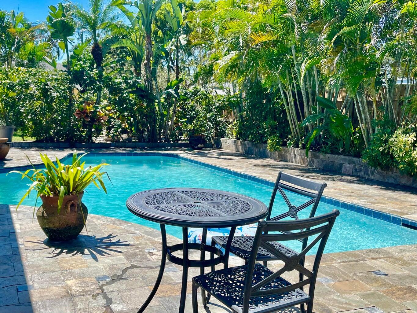 1259 Denlow Lane Royal Palm Beach, FL 33411 - Photo 28 of 40 a patio with table and chairs and potted plants