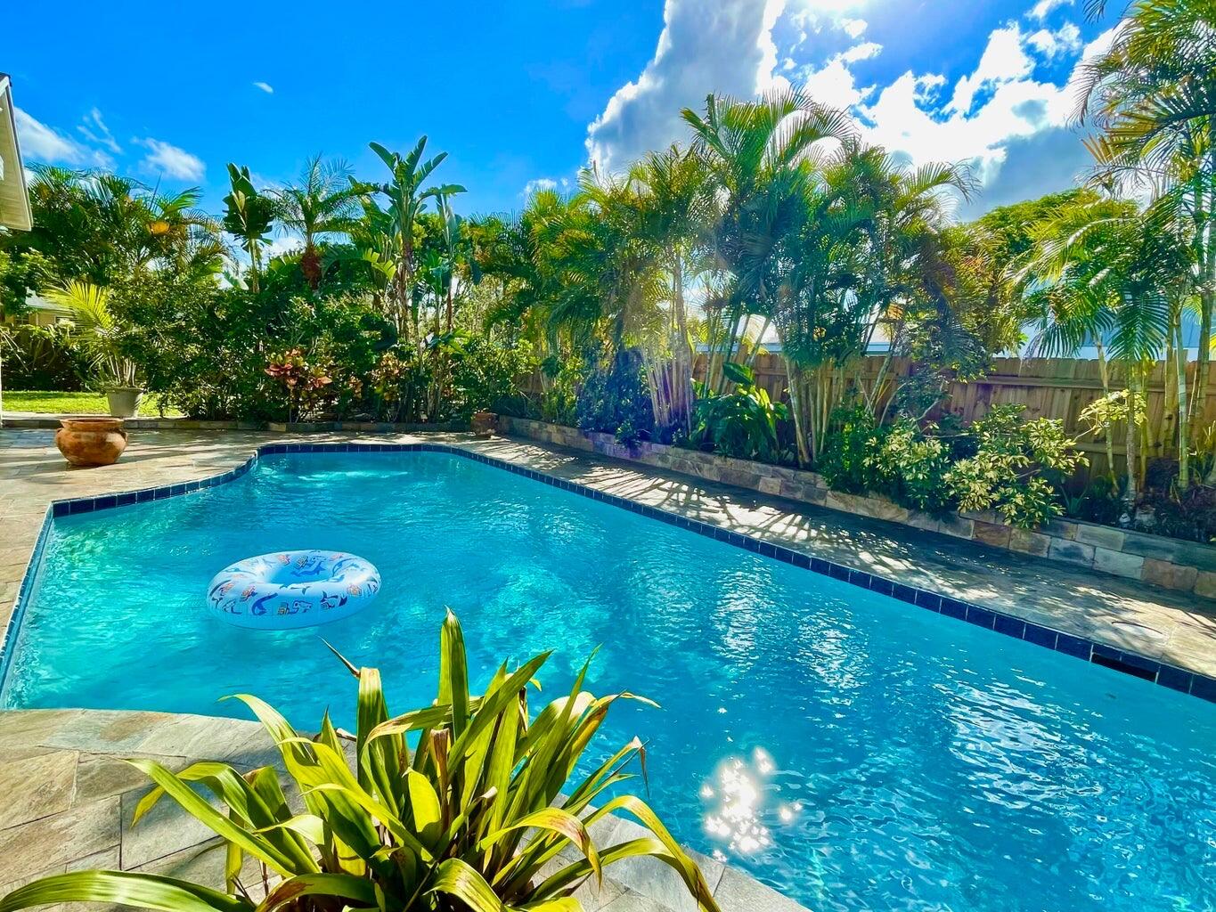 1259 Denlow Lane Royal Palm Beach, FL 33411 - Photo 30 of 40 a view of a swimming pool with a yard