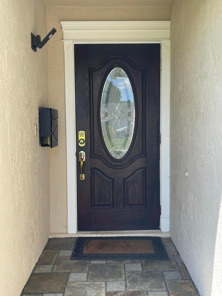 1259 Denlow Lane Royal Palm Beach, FL 33411 - Photo 3 of 40 a view of a entryway door with wooden floor
