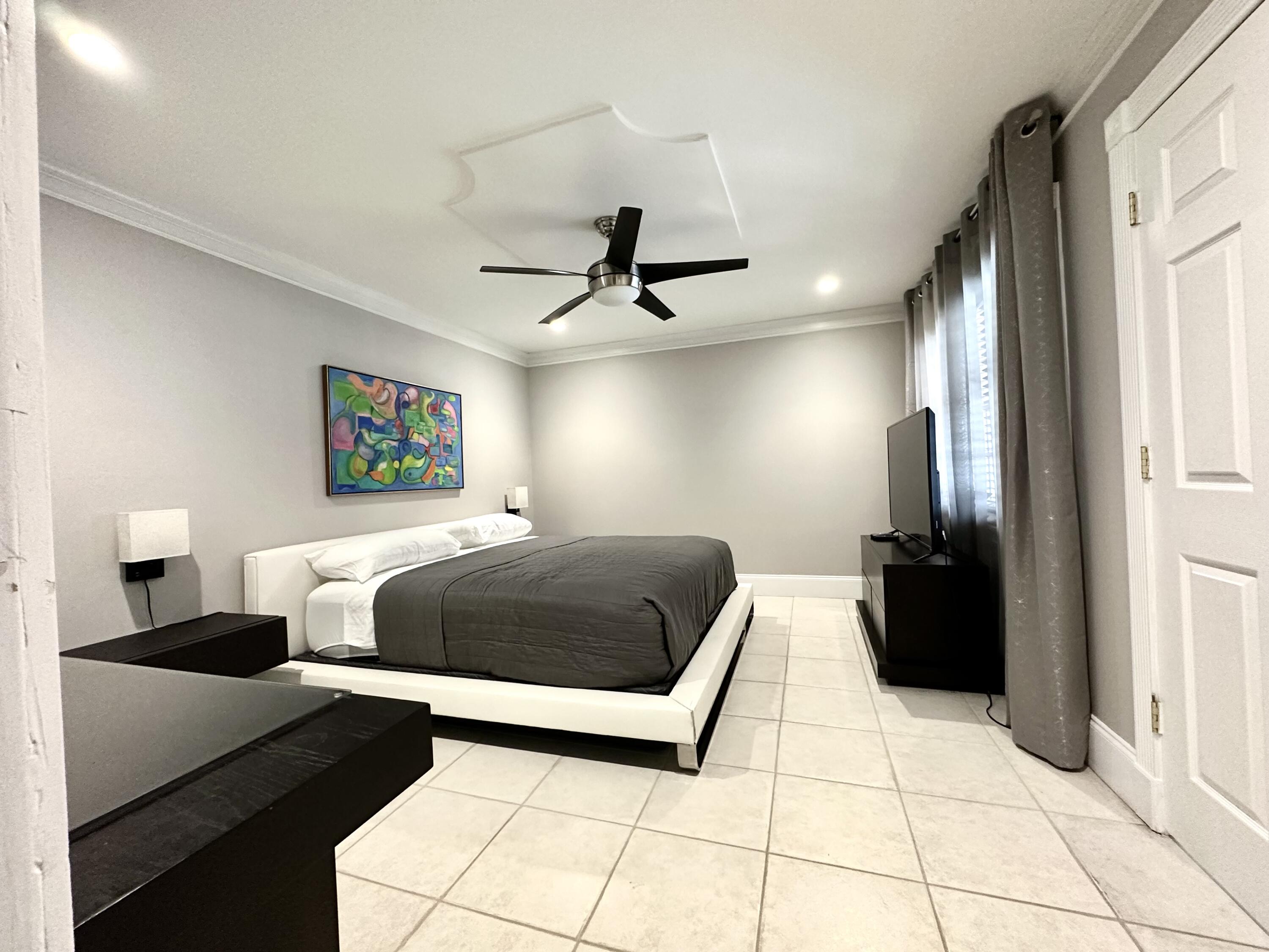 1259 Denlow Lane Royal Palm Beach, FL 33411 - Photo 31 of 40 a bedroom with a bed and a walk in closet