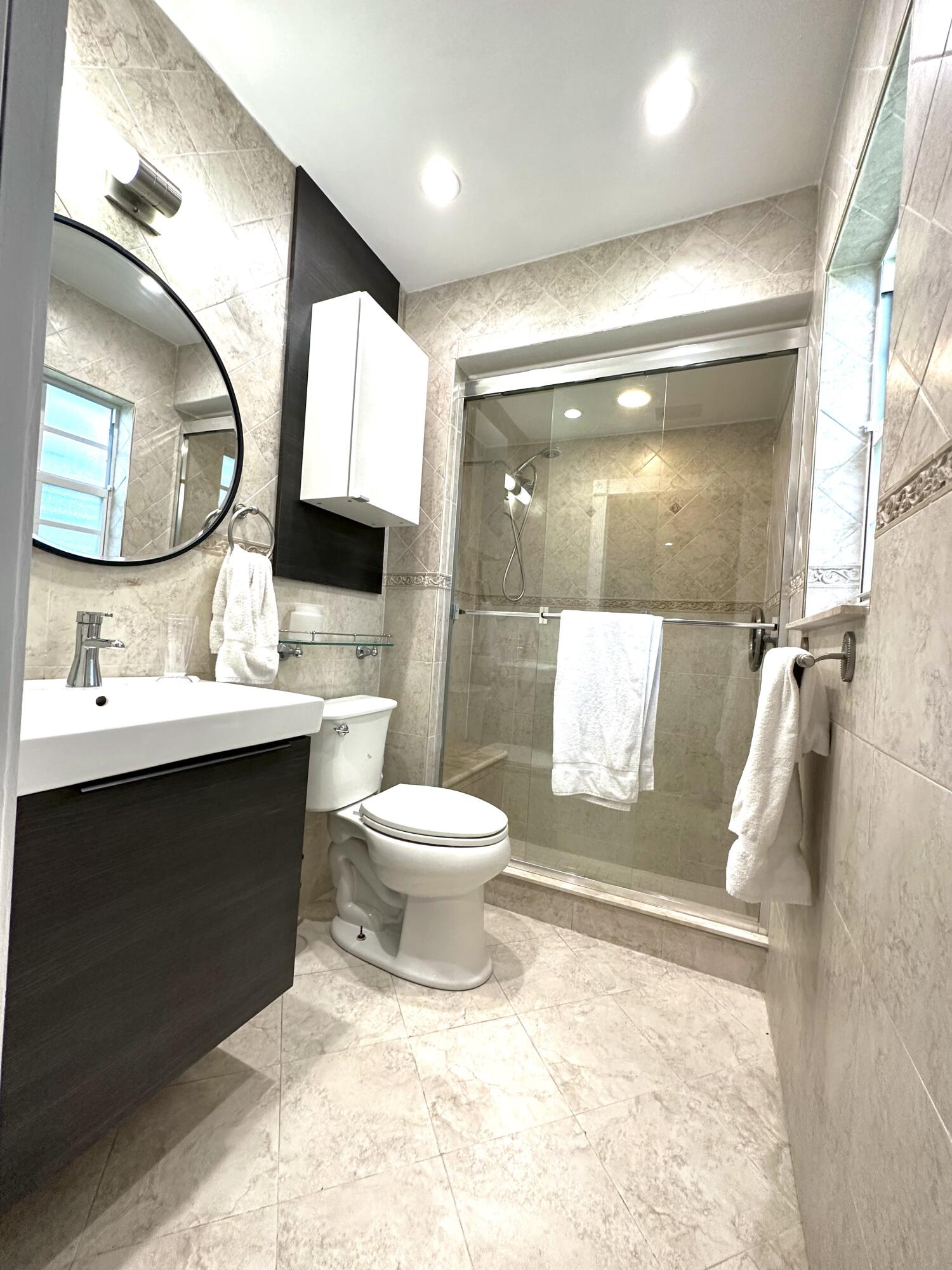 1259 Denlow Lane Royal Palm Beach, FL 33411 - Photo 32 of 40 a bathroom with a sink toilet and shower