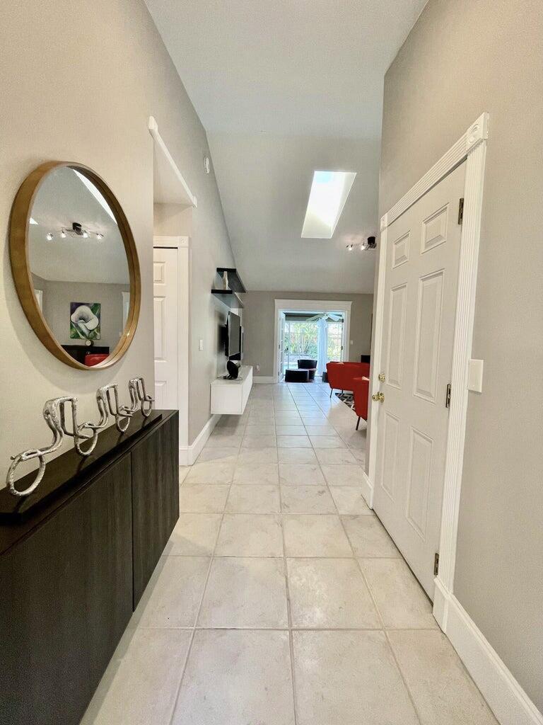 1259 Denlow Lane Royal Palm Beach, FL 33411 - Photo 4 of 40 a hallway with a washer and dryer