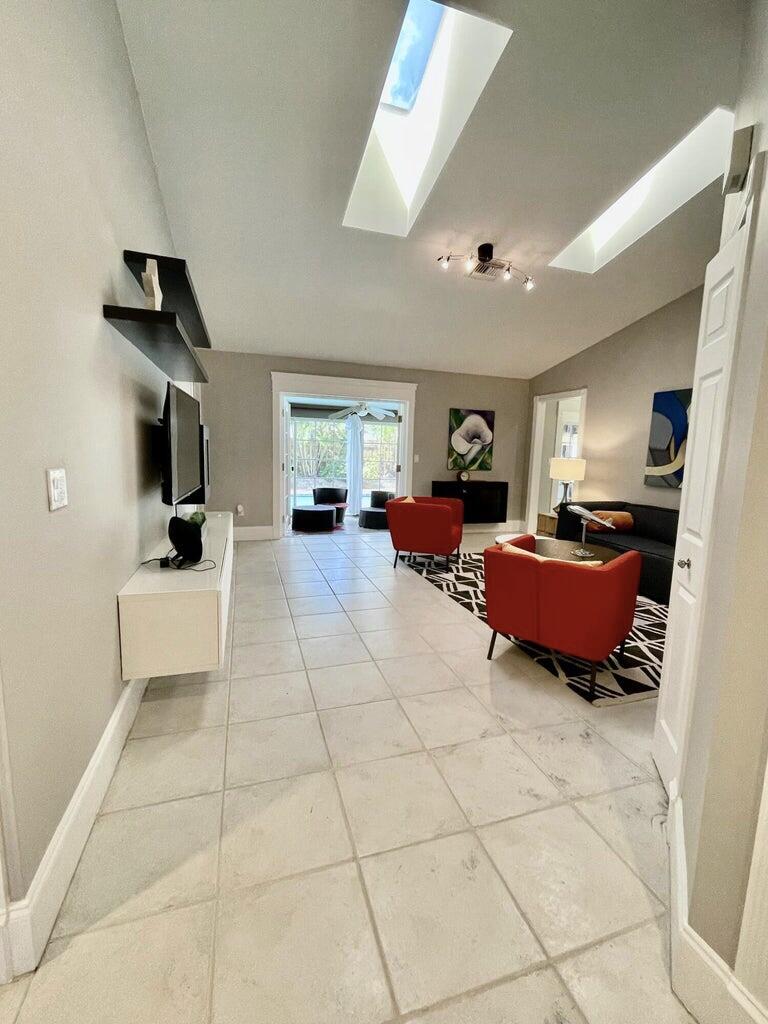 1259 Denlow Lane Royal Palm Beach, FL 33411 - Photo 5 of 40 a living room with furniture and a flat screen tv