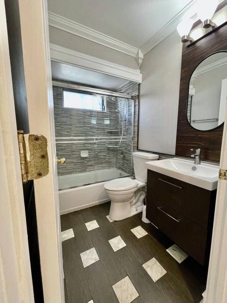 1259 Denlow Lane Royal Palm Beach, FL 33411 - Photo 6 of 40 a bathroom with a sink and a mirror