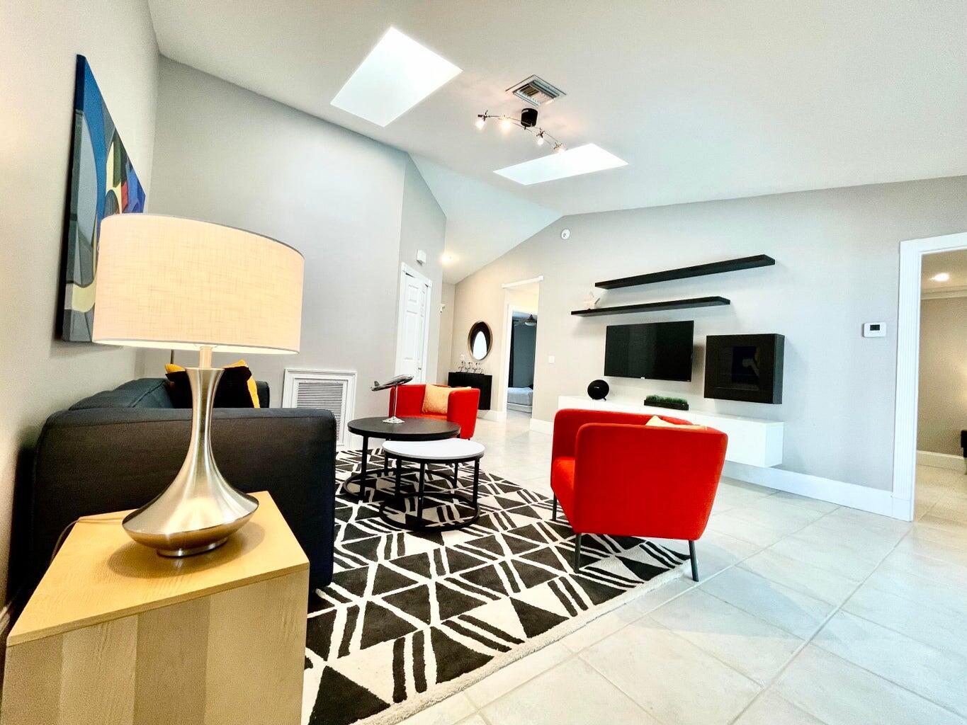 1259 Denlow Lane Royal Palm Beach, FL 33411 - Photo 10 of 40 a living room with furniture and a flat screen tv