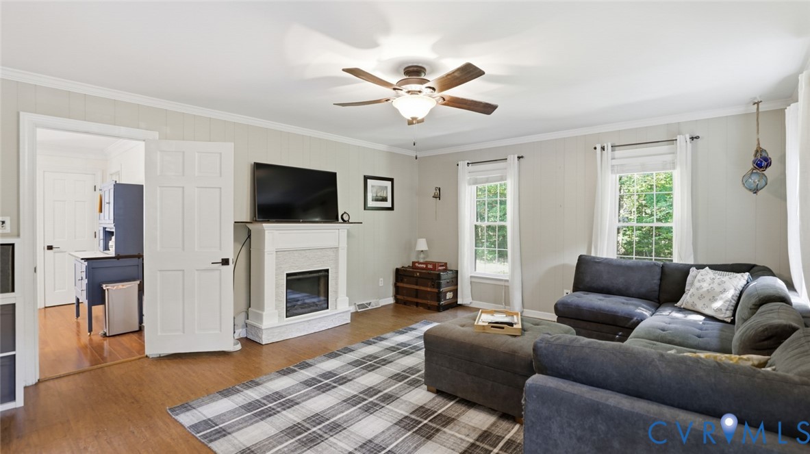 10716 Chalkley Road Richmond, VA 23237 - Photo 23 of 46 a living room with furniture a flat screen tv and a fireplace