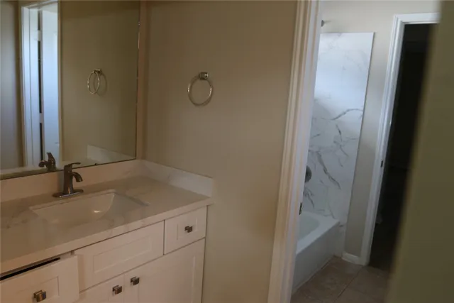 a bathroom with a sink and mirror