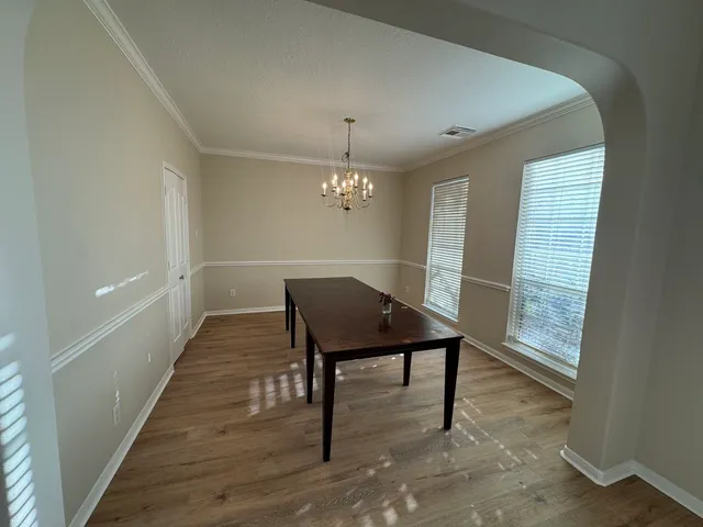 a workspace with furniture window and wooden floor