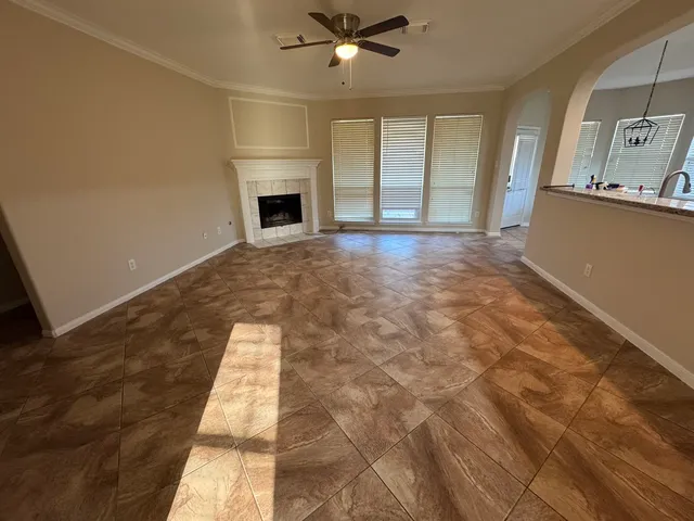 wooden floor in an empty room with a fireplace
