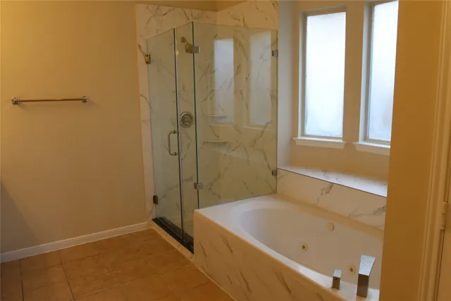 a bathroom with a tub and shower