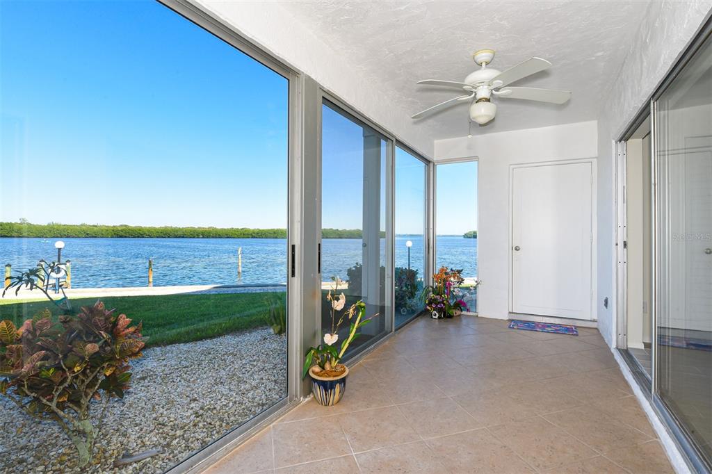 4440 Exeter Drive, Unit N106 Longboat Key, FL 34228 - Photo 1 of 1 a living room with furniture and a floor to ceiling window