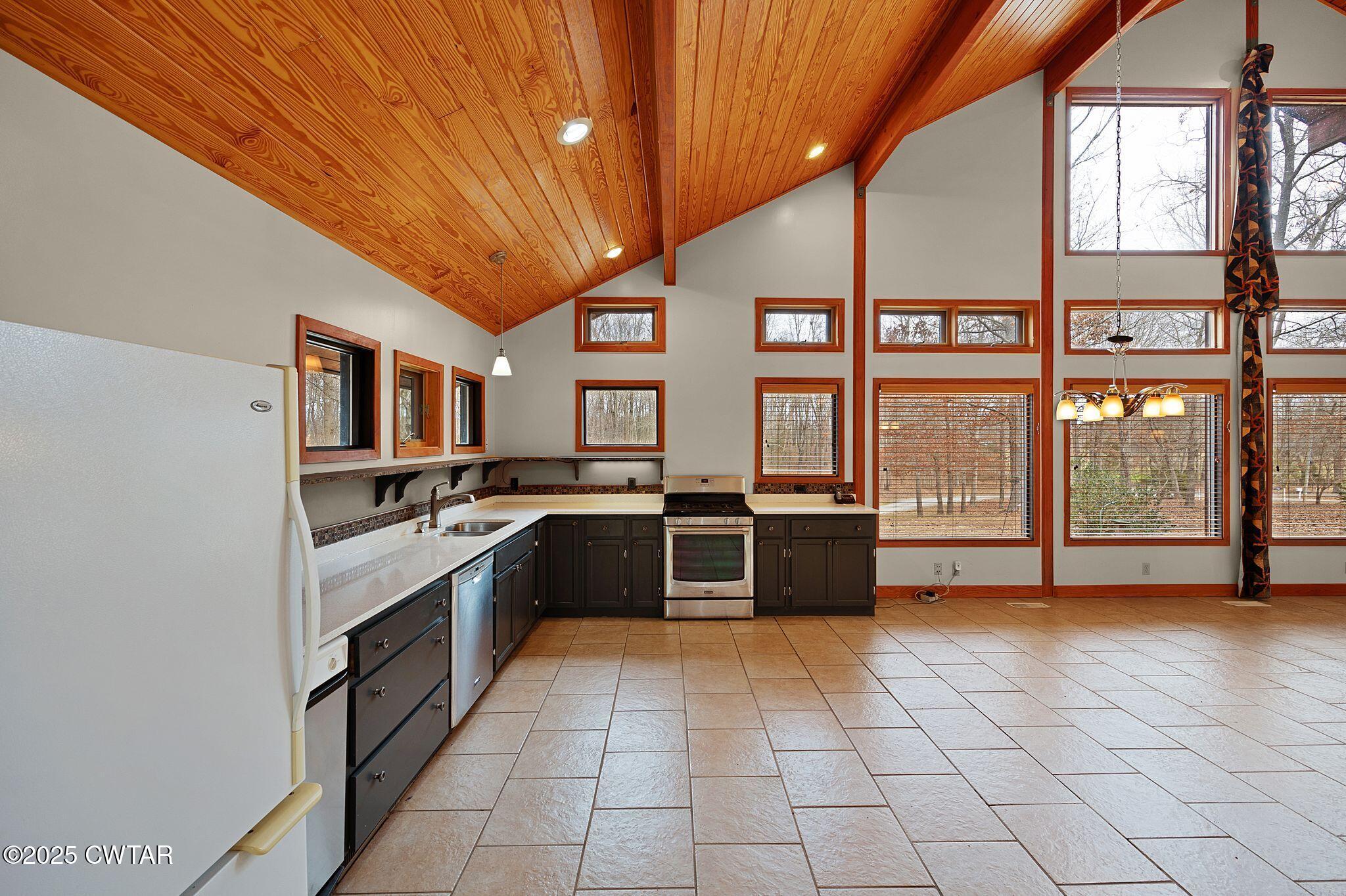 1273 Palmer Road Lexington, TN 38351 - Photo 15 of 62 a large kitchen with stainless steel appliances granite countertop a large stove top oven and cabinets